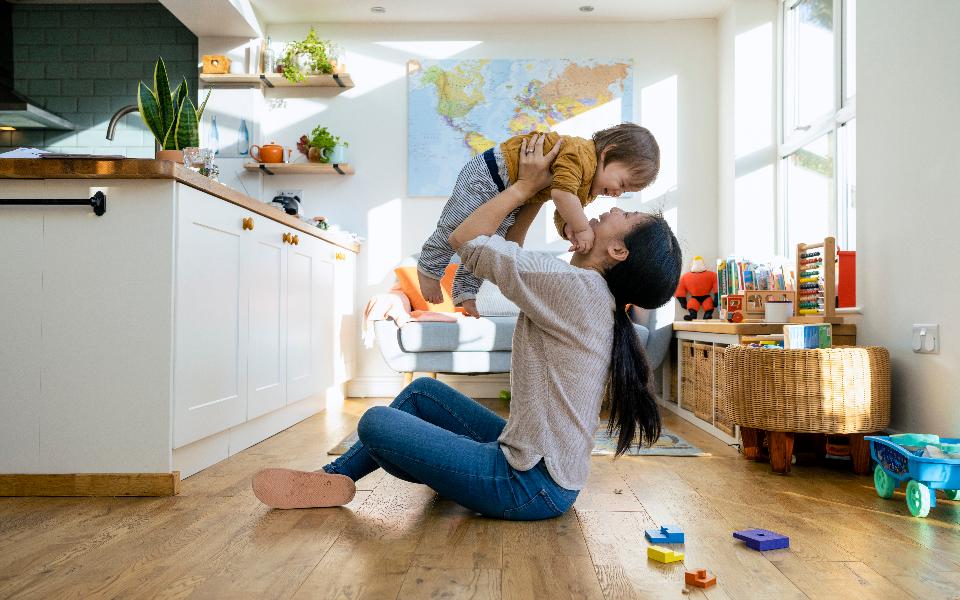 Mum holding up young child