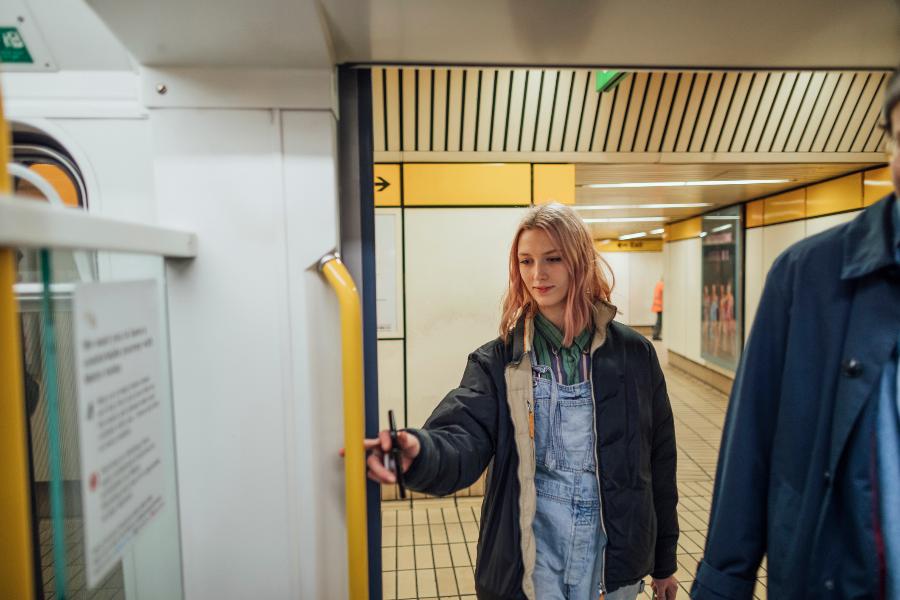 Young person getting on a Metro