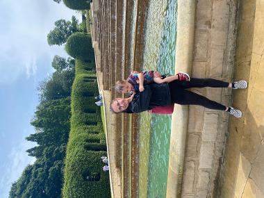 Young person with child next to a fountain